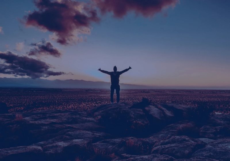 Image of someone stood in an open landscape